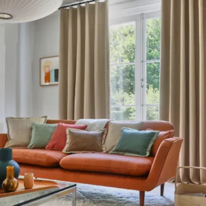 brown misc cushion with curtain and sofa