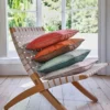 brown misc cushion with armchair and curtain