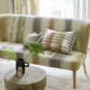 brown striped sofa with cushion and vases