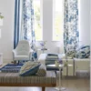 blue botanical curtain with armchair and bed