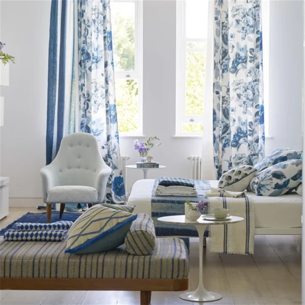 Camellia Fabric - Indigo by blue botanical curtain with armchair and bed