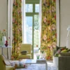 pink botanical curtain with armchair and window
