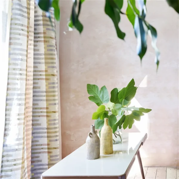 multicolour striped curtain with coffee table and vases
