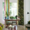 green botanical curtain with dining table and armchair