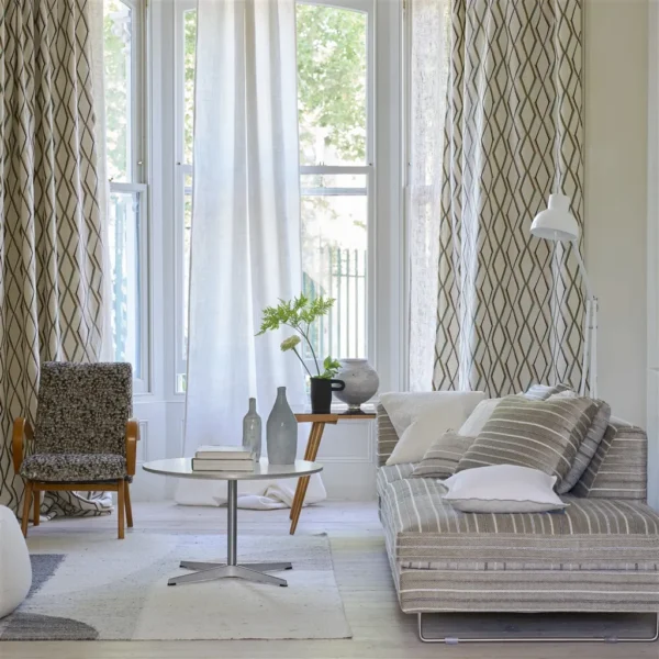 Porthminster Fabric - Chalk by multicolour striped curtain with sofa and armchair