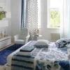 blue spotted curtain with bed and armchair