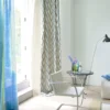 blue geometric curtain with armchair and vases