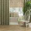 green botanical curtain with cushion and chair