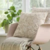 neutral botanical cushion with chair and plants