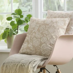 neutral botanical cushion with chair and plants