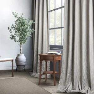 blue striped curtain with side table and plants