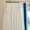 white curtain with blue velvet border on leading edge