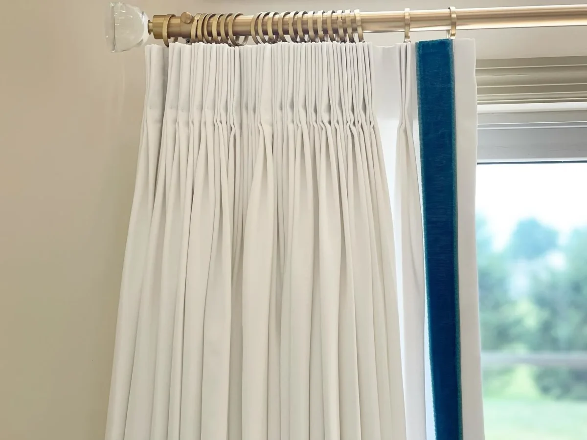 Sloane 1" Velvet Border by white curtain with blue velvet border on leading edge