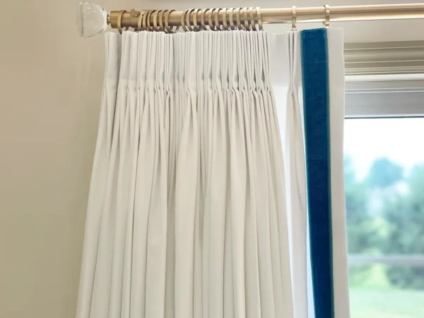 Sloane 2" Velvet Border by white curtain with blue velvet border on leading edge