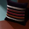 dark purple cushion with velvet border stripes across centre