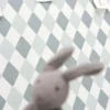 blue geometric wallpaper and wall with toys
