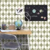 green geometric wallpaper and wall with side table and chair