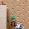 brown botanical wallpaper and wall with cushion and toys