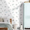 blue botanical wallpaper and wall with bed and toys