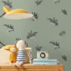 green botanical wallpaper and wall with cabinets and toys