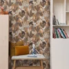 brown botanical wallpaper and wall with side table and toys