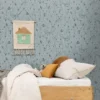 blue children's wallpaper and wall with bed and toys