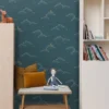 blue children's wallpaper and wall with side table and toys