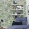 green botanical wallpaper and wall with bed and toys