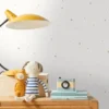 white spotted wallpaper and wall with lamps and toys