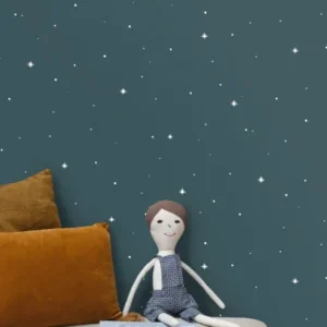 blue spotted wallpaper and wall with cushion and toys