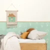 white spotted wallpaper and wall with bed and cushion