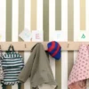 green striped wallpaper and wall with clothes