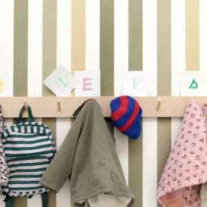 green striped wallpaper and wall with clothes
