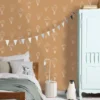 white children's wallpaper and wall with bed and toys