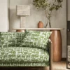 green animal sofa with side table and lamps
