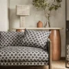 black-grey spotted sofa with side table and lamps