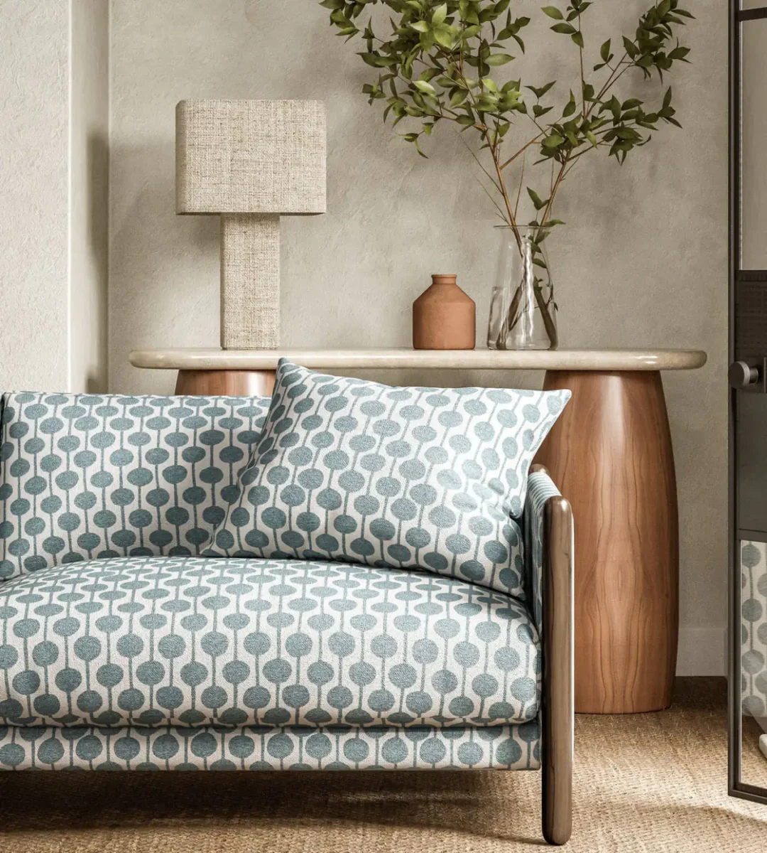 blue spotted sofa with side table and lamps