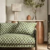 green spotted sofa with side table and lamps