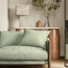 green geometric sofa with side table and lamps