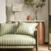 green striped sofa with side table and lamps