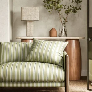green striped sofa with side table and lamps