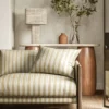 yellow striped sofa with side table and lamps