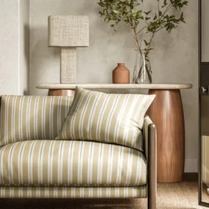 yellow striped sofa with side table and lamps