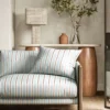 blue striped sofa with side table and lamps