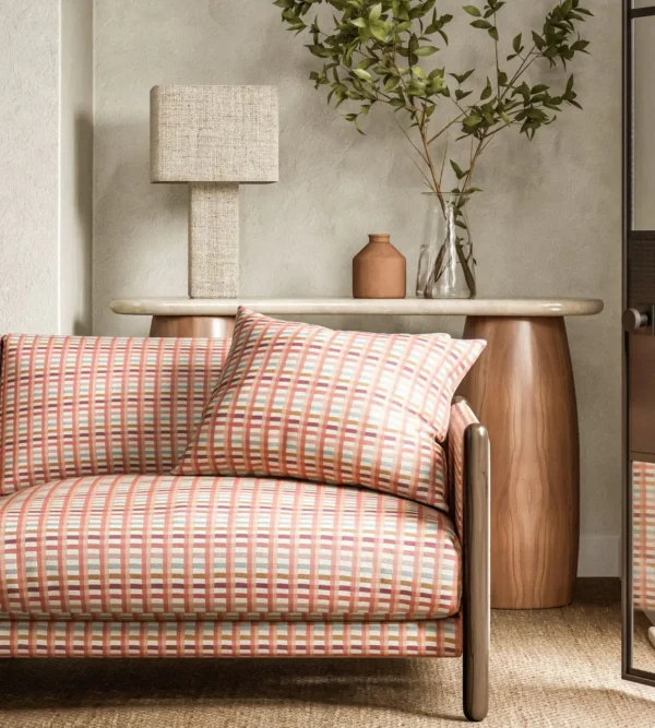 Charnwood Fabric - Terracotta by red striped sofa with side table and lamps