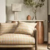 yellow striped sofa with side table and lamps