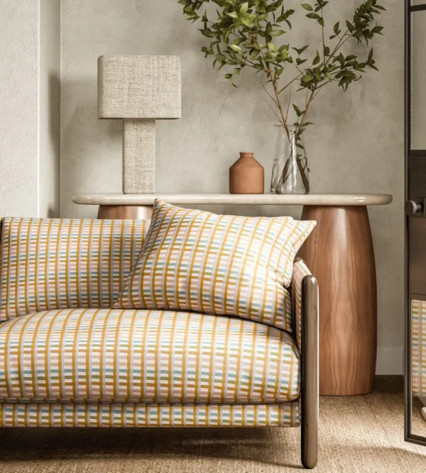 Charnwood Fabric - Honey by yellow striped sofa with side table and lamps