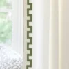 green geometric border on white curtain