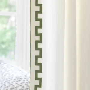 green geometric border on white curtain