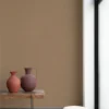 brown plain wallpaper and pouf with vases